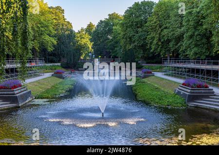 Fountains and large classic pond surrounded with flowers in public park Noorderplantsoen in Groningen city in The Netherlands Stock Photo