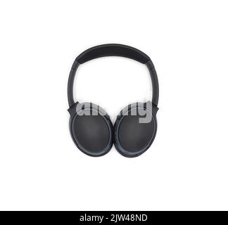 Black wireless headphone around ears and white background and isolated. Stock Photo