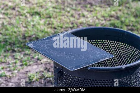 Modern tablet with highly broken screen lies on the trash Stock Photo