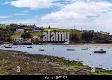 Clonakilty, Ireland, July 2, 2022. The coast of Ireland. Small fishing boats are anchored in bay at low tide. Picturesque seascape. European fishing v Stock Photo