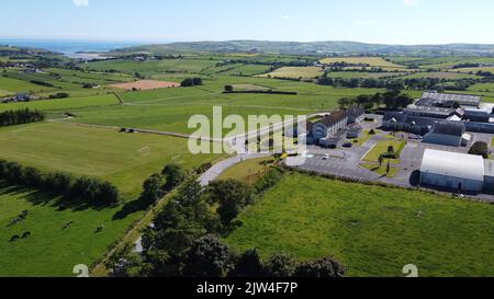 West Cork, Ireland, July 9, 2022. Clonakilty Agricultural College, fields on a sunny summer day, buildings on green grass field, top view. Stock Photo