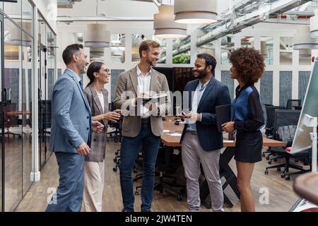 Multiethnic group of business people talking in office during break. Teamwork concept Stock Photo