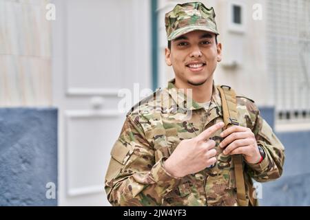 Young arab man wearing camouflage army uniform asking to be quiet with ...