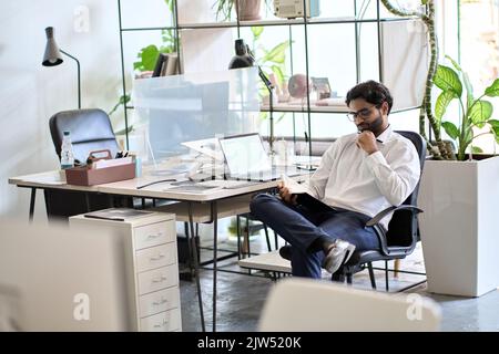 Busy indian business man manager working in office checking agenda. Stock Photo