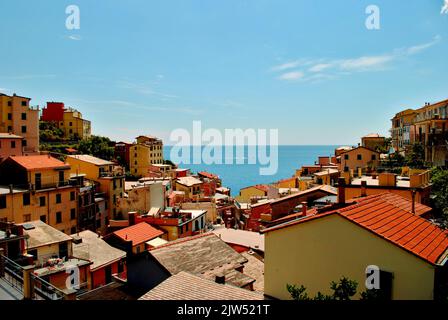 View of rooftops in colorful village by the sea and blue sky Stock Photo