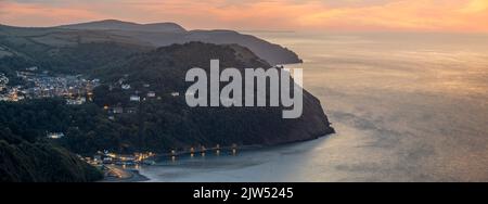 The view after sunset from the top of Countisbury Hill on the northern edge of Exmoor, looking towards Lynton and Lynmouth in North Devon, England. Th Stock Photo