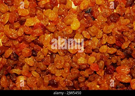 Texture of yellow raisins from white grapes. Raisins background. Stock Photo