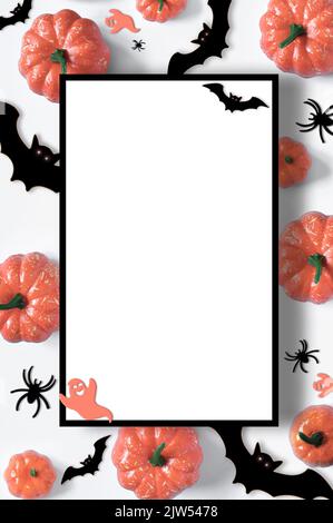 Happy Halloween holiday flat lay composition with pumpkins, spiders, bats on white background. Halloween banner mockup, greeting card design Stock Photo