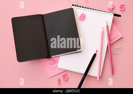 School accessories stationery supplies on pink background, flat lay copy space. Stock Photo