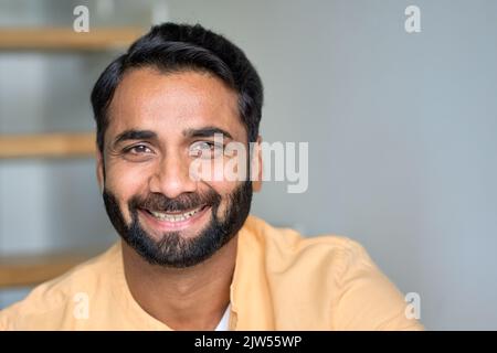 Happy smiling indian man looking at camera at home indoors. Close up portrait. Stock Photo