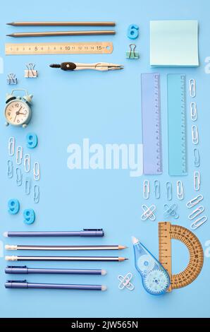 School accessories stationary supplies on blue background, geometric flat lay. Stock Photo