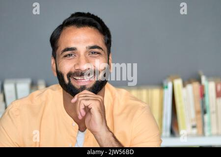 Happy smiling indian man looking at camera at home indoors. Close up portrait. Stock Photo