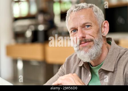 Happy middle aged old gray-haired bearded man close up headshot portrait. Stock Photo