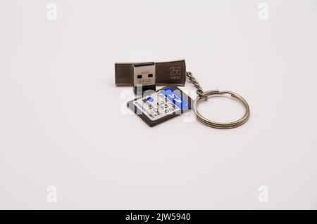 close-up of three USB 3.1 portable storage device sticks, one on a key ring chain Stock Photo