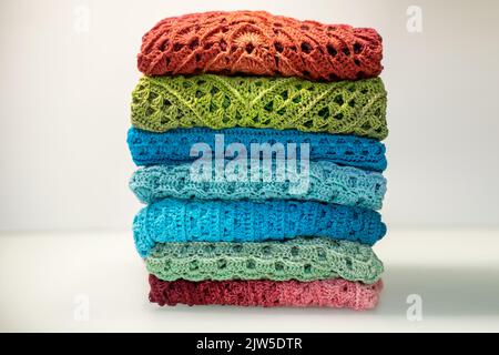 a stack of multi-colored knitted things on a white background. Stock Photo