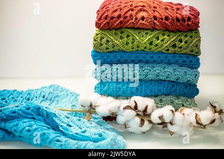 a stack of multi-colored knitted things on a white background. Stock Photo