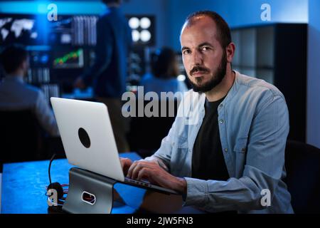 Stock Market Trader Working Investment Charts, Graphs, Ticker, Diagrams. Financial Analyst and Digital Business man Selling Shorts and Buying Longs Stock Photo