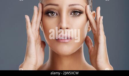Putting her best face forward. a beautiful young woman posing in the studio. Stock Photo