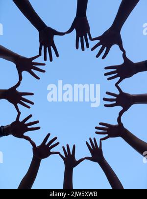 Forming a partnership together. a group of hands spread out together in a circle. Stock Photo