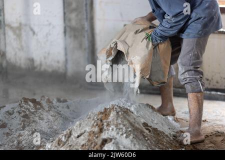 Unsafe construction of Myanmar migrant workers while pouring concrete slab in construction site , Thailand. Stock Photo