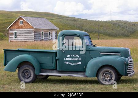 Mercury half ton 1940s old green farm truck with logo on Bar U Ranch National Historic Site in southern Alberta, Canada Stock Photo