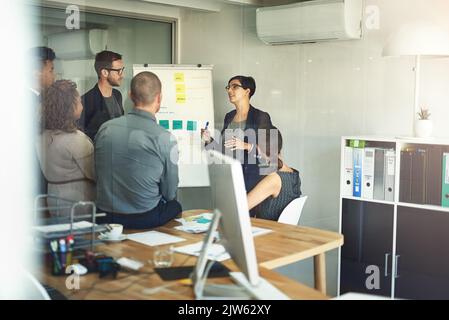 Streamlining her teams workflow. a presentation in progress in a modern office. Stock Photo