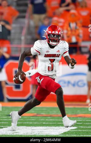 Louisville quarterback Malik Cunningham (3) runs from the grasp of ...