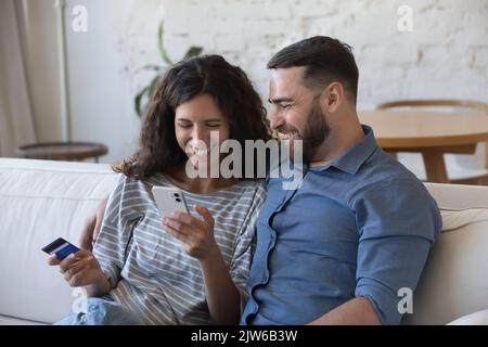 Couple buy on internet use credit card and smart phone Stock Photo