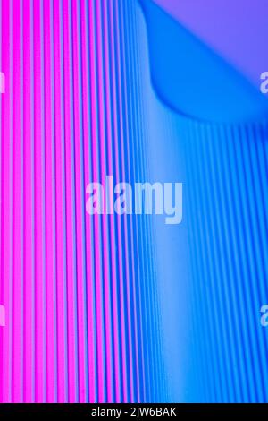 Abstract geometric background with pink and blue hues. Corrugated lines futuristic backdrop. Stock Photo