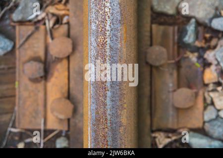 old rusty rail close-up on a rotten wooden railway sleeper  Stock Photo