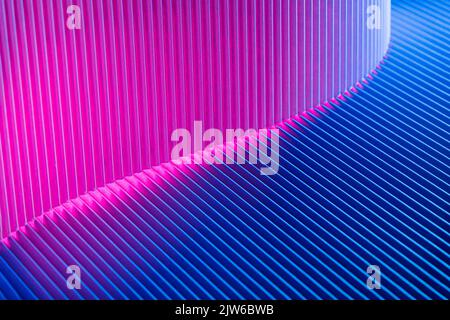 Abstract geometric background with magenta and blue hues. Corrugated lines futuristic backdrop. Stock Photo