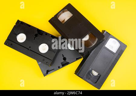 Some old VHS videotapes on a yellow surface Stock Photo