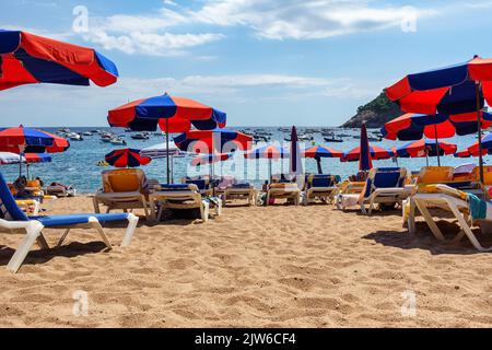 Hammocks and umbrellas on the sand of the beach on a hot summer day, Spain. Stock Photo