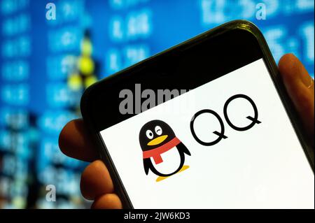 In this photo illustration, the Chinese instant messaging software service developed by Shenzhen Tencent Computer company, QQ, logo is displayed on a smartphone screen. Stock Photo