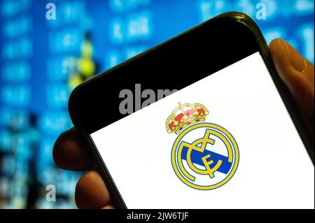 China. 25th July, 2022. In this photo illustration, the Spanish professional football club team Real Madrid Club de Fútbol commonly known as Real Madrid logo is displayed on a smartphone screen. (Photo by Budrul Chukrut/SOPA Images/Sipa USA) Credit: Sipa USA/Alamy Live News Stock Photo