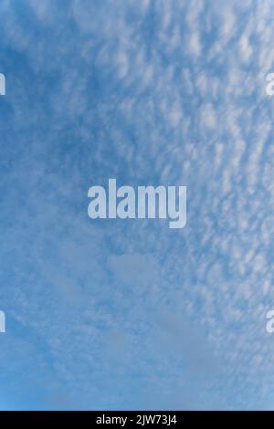 Blue sky with wispy white cirrus clouds on summer day Stock Photo