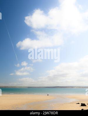 Dreaming of St Ives, stunning beach image with a couple taking a walk early morning on the golden sands. Stock Photo