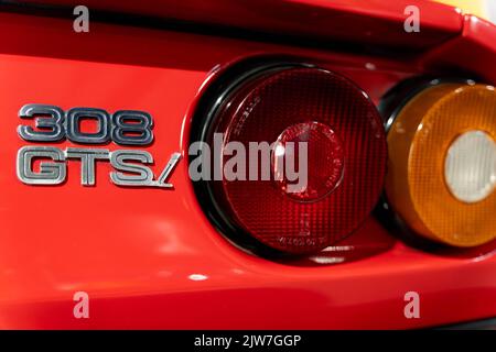 Close-up of Ferrari 308 GTS rear lights and badge detail on classic red sports car Stock Photo