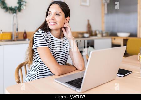 Serene young woman having a break from working on laptop computer at home Stock Photo