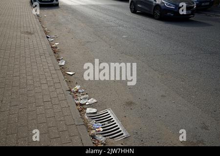 Rubbish or trash at the side of a road in London, England. An unattractive sight. An unhealthy environment. Stock Photo