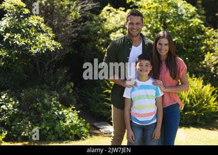 Portrait of caucasian family spending time in their garden together Stock Photo