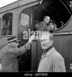 Image of president director Dr. Ir. F.Q. Den Hollander who steps on board from the steam locomotive No. 3737 (series 3701-3815) of the N.S. During her last ride. Stock Photo