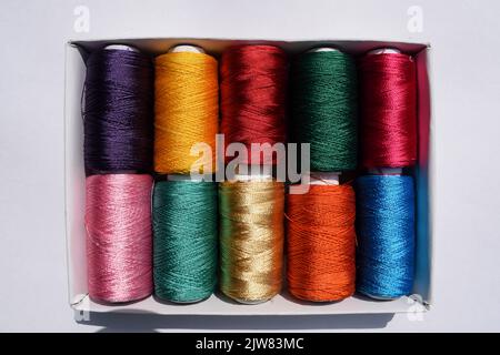 Top view of Multi color Silk thread spools. Silk threads of many different colours shiney threads for crafting and fabric stitching and embroidery Stock Photo