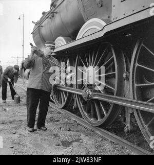 Image of lubricating the connecting rods of the steam locomotive No. 3737 (series 3701-3815) of the N.S. During her last ride. Stock Photo