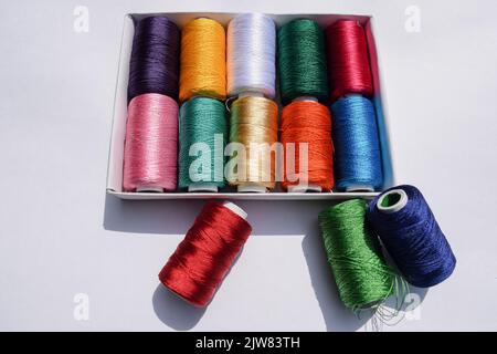 Top view of Multi color Silk thread spools. Silk threads of many different colours shiney threads for crafting and fabric stitching and embroidery Stock Photo