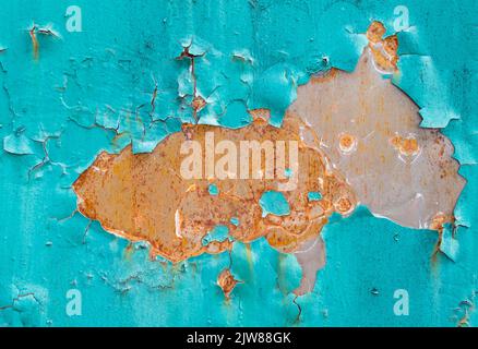 Brown rust with peeling blue paint on old metal fence Stock Photo