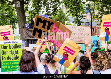 London, UK. 3 September 2022.  Pro-choice abortion campaigners display messaging of women's rights to choose during a March for Choice rally in Parliament Square in opposition to a rally also being held by anti-abortion campaign groups.