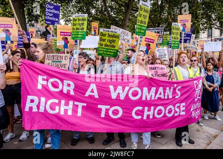 London, UK. 3 September 2022.  Pro-choice abortion campaigners display messaging of women's rights to choose during a March for Choice rally in Parliament Square in opposition to a rally also being held by anti-abortion campaign groups.