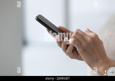 Black mobile phone in female hands close up side view Stock Photo