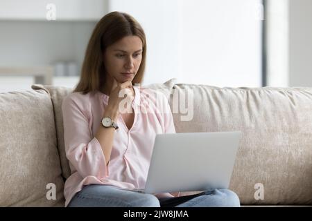 Freelance woman using laptop with CUSTOMER EXPERIENCE inscription ...
